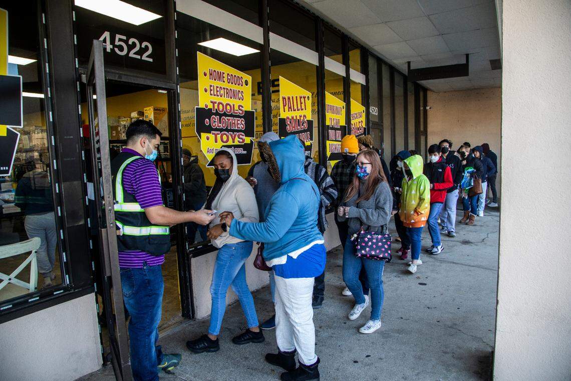 Shoppers line up outside Treasure Hunt Liquidators Friday, Jan. 14, 2022 in Raleigh. he 4,000-square-foot space features bargain bins that refill each Friday offering products from retailers like Target, Best Buy and Amazon returns.