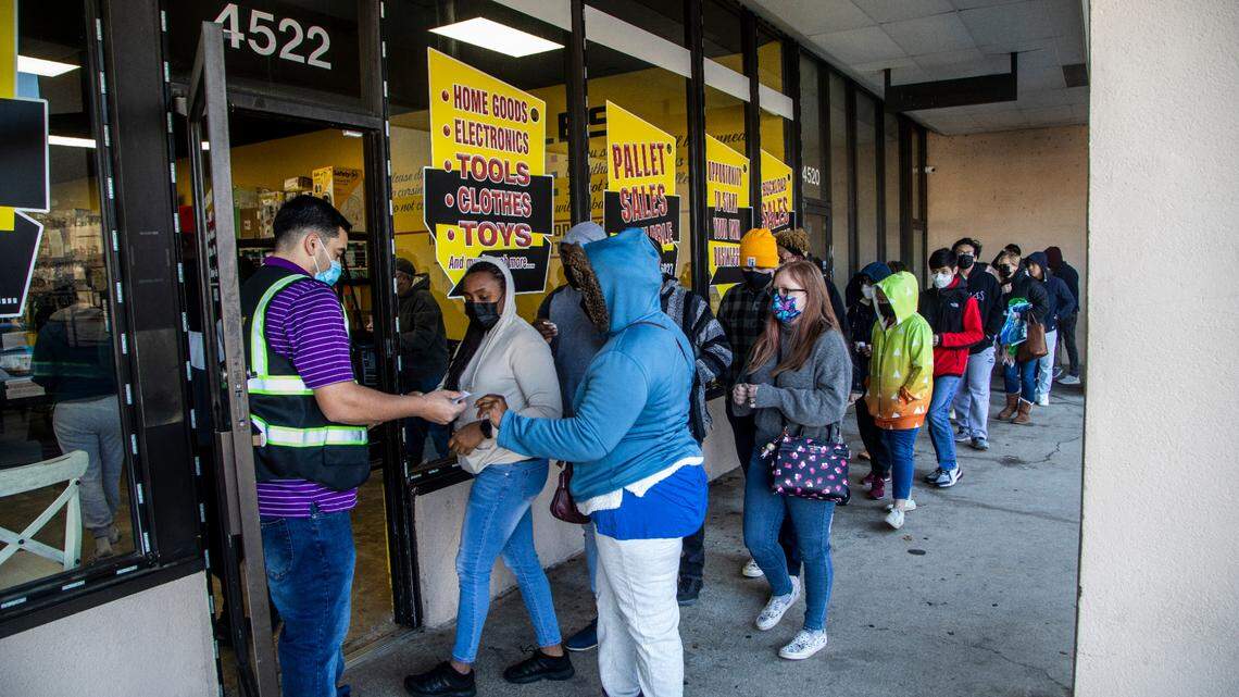 Shoppers line up outside Treasure Hunt Liquidators Friday, Jan. 14, 2022 in Raleigh. The 4,000-square-foot space features bargain bins that refill each Friday offering products from retailers like Target, Best Buy and Amazon returns.