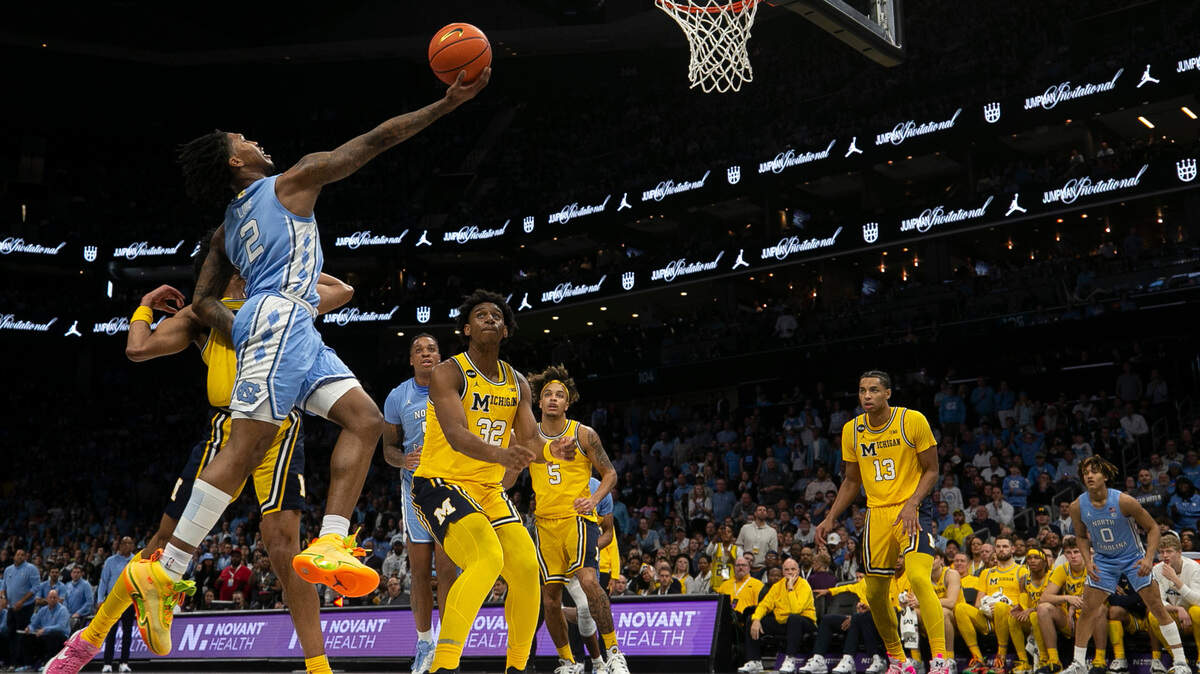 North Carolina’s Caleb Love (2) drives to the basket against Michigan’s Kobe Bufkin (2) in the first half on Wednesday, December 21, 2022 at the Spectrum Center in Charlotte, N.C.