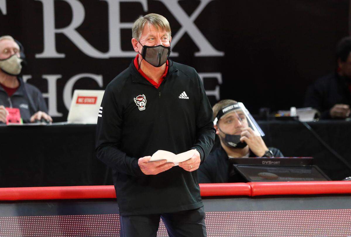 N.C. State head coach Wes Moore smiles as he watches during the second half of N.C. State’s 83-53 victory over Pittsburgh at Reynolds Coliseum in Raleigh, N.C., Thursday, February 25, 2021.