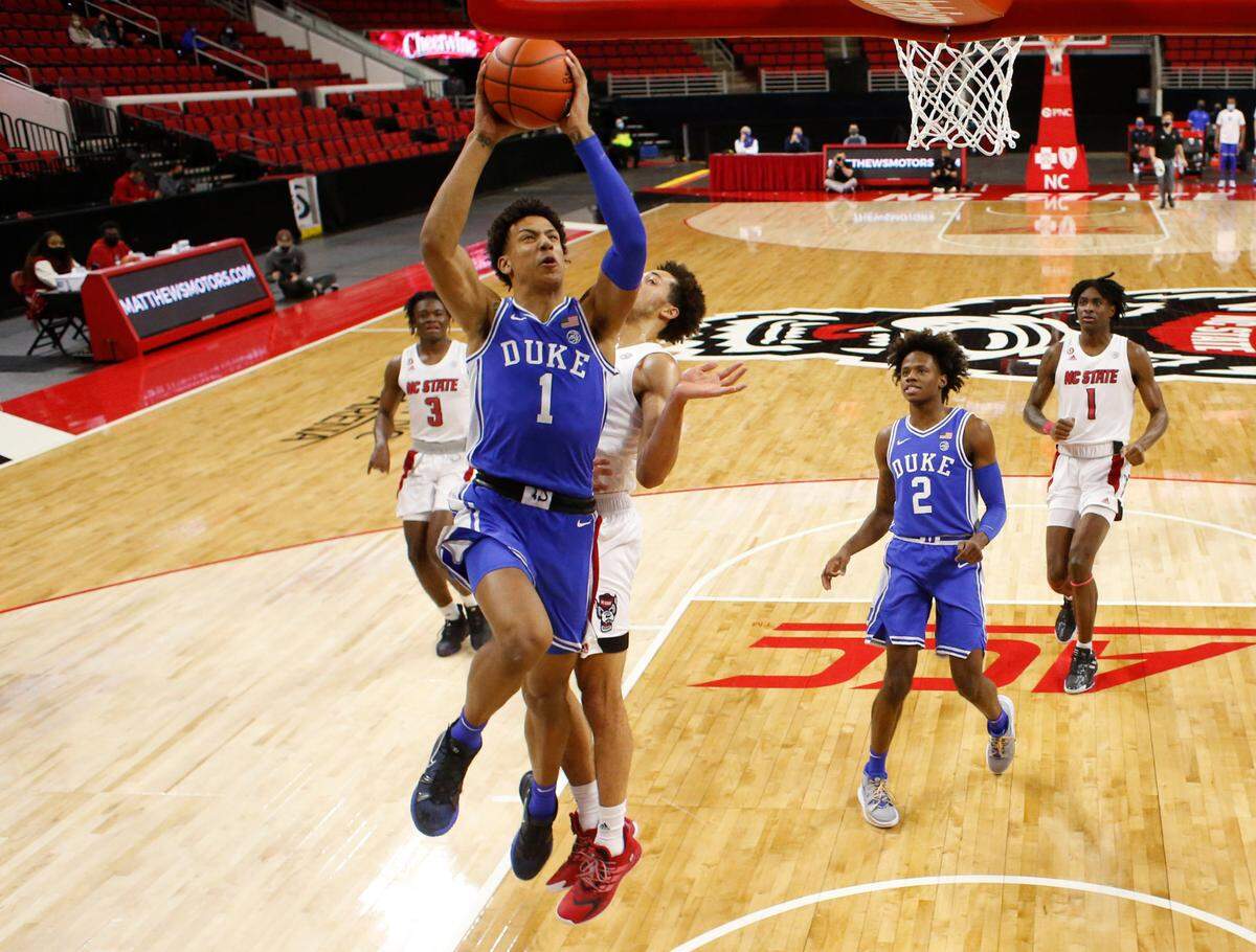 Duke’s Jalen Johnson (1) heads to the net past N.C. State’s Jericole Hellems (4) during Duke’s 69-53 victory over N.C. State at PNC Arena in Raleigh, N.C., Saturday, February 13, 2021.