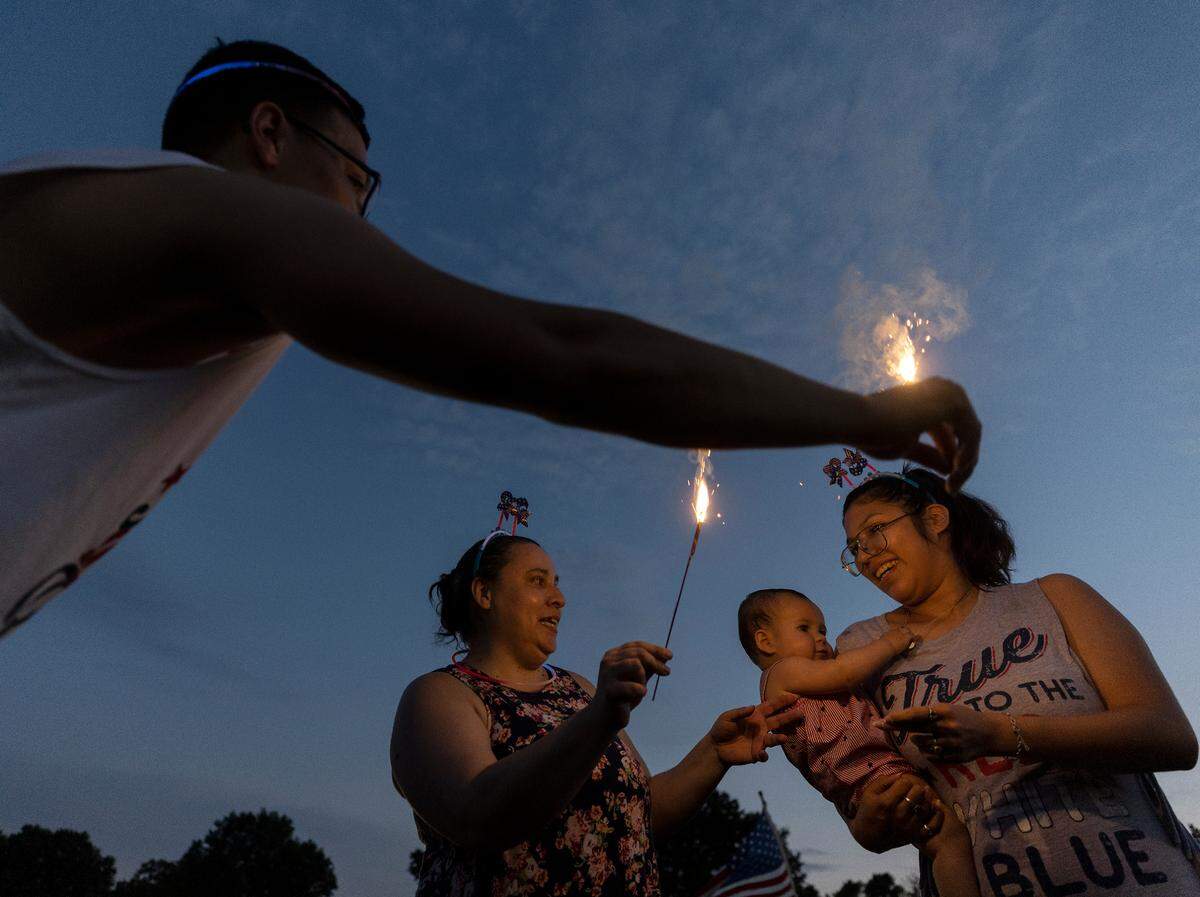 People light sparklers during an Independence Day celebration at Dorothea Dix Park on Tuesday, July 4, 2023, in Raleigh, N.C.
