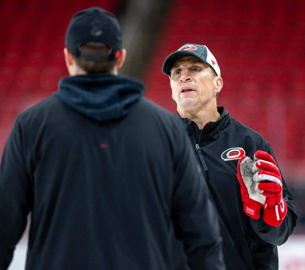 Carolina Hurricanes coach Rod Brind’Amour talks with assistant coach Tim Gleason as they prepare for their Stanley Cup series against the Washington Capitals on Friday, May 2, 2025 at Lenovo Center in Raleigh, N.C. 