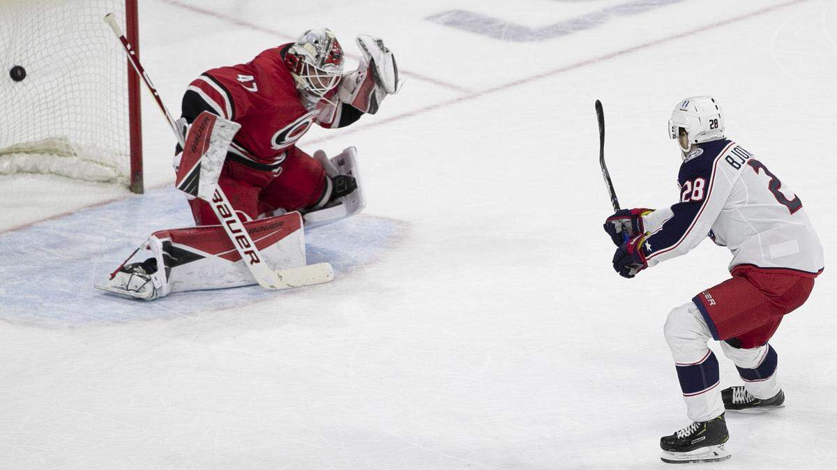 Columbus Blue Jackets’ Oliver Bjorkstrand (28) fires the game winning on Carolina Hurricane’s goalie James Reimer (47) to secure a 3-2 victory on Saturday, March 20, 2021 at PNC Arena in Raleigh, N.C.