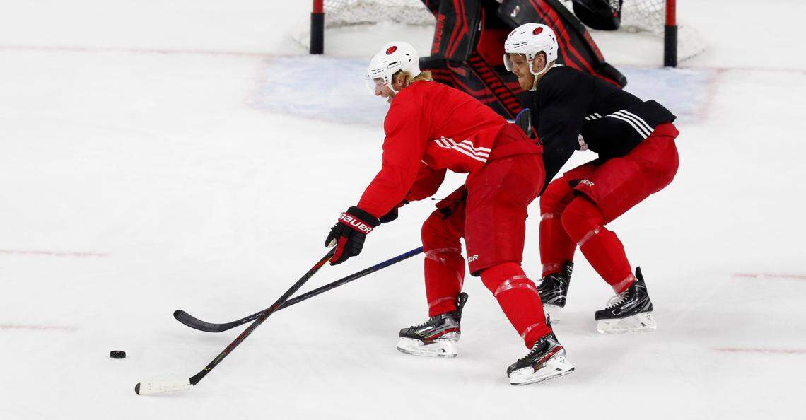Carolina center Jordan Staal (11), left, battles Carolina defenseman Dougie Hamilton (19) during the Carolina Hurricanes’ on-ice workouts at PNC Arena in Raleigh, N.C., Monday, July 13, 2020.