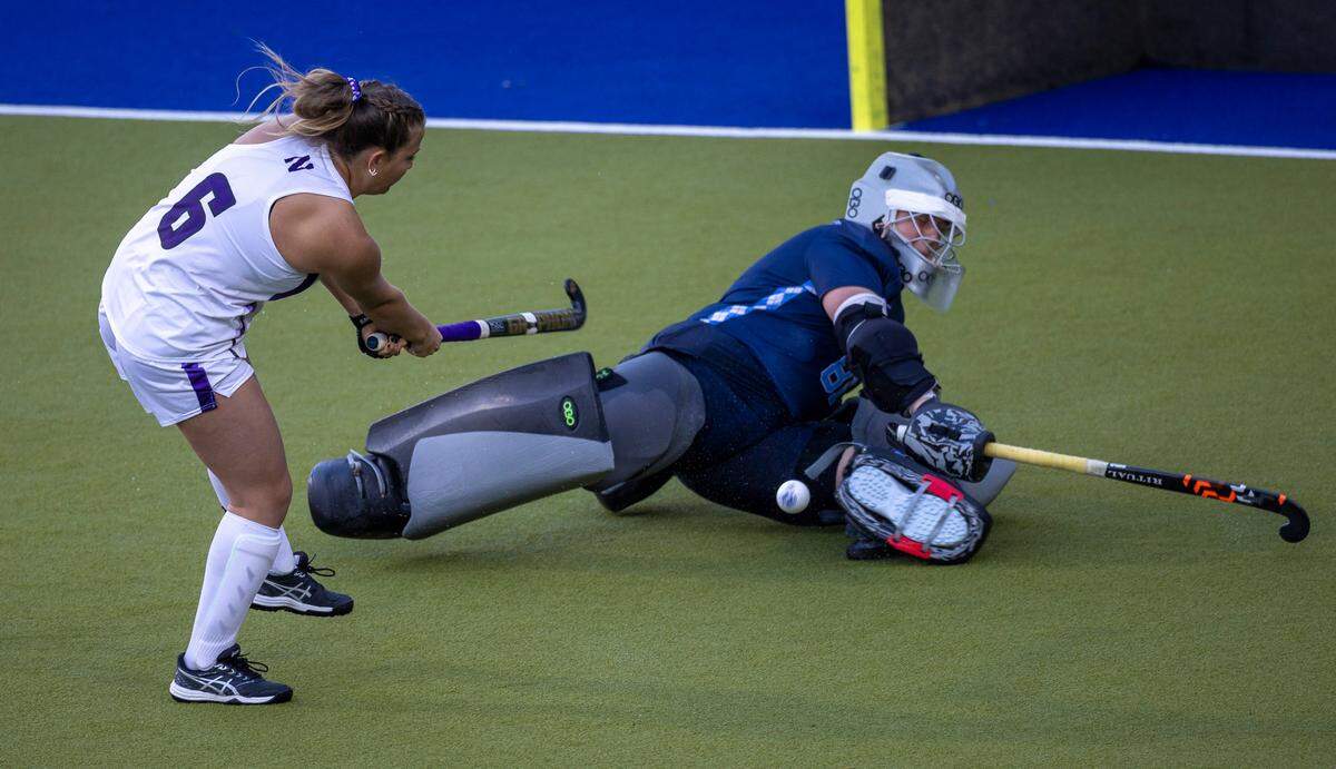 North Carolina goalie Maddie Kahn (81) stops a shot by Northwestern’s (6) Peyton Halsey in the sudden death shootout during the NCAA Division I Field Hockey Championship on Sunday, November 19, 2023 at Karen Shelton Stadium in Chapel Hill, N.C. Kahn was selected the MVP of the Championship.