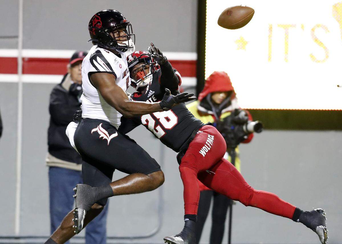 N.C. State cornerback Kishawn Miller (28) is called for pass interference while defending Louisville wide receiver Seth Dawkins (5) during the second half of Louisville’s 34-20 victory over N.C. State at Carter-Finley Stadium in Raleigh, N.C., Saturday, November 16, 2019.
