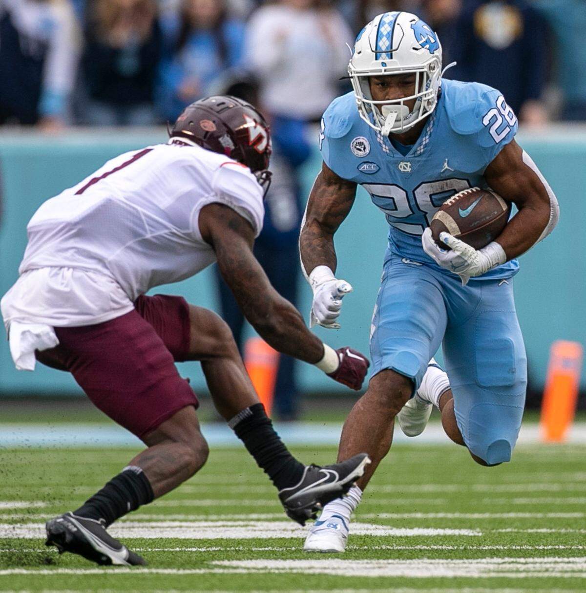 Virginia Tech’s Chamarri Conner (1) works to stop North Carolina’s Omarion Hampton (28) in the first quarter on Saturday, October 1, 2022 at Kenan Stadium in Chapel Hill, N.C.