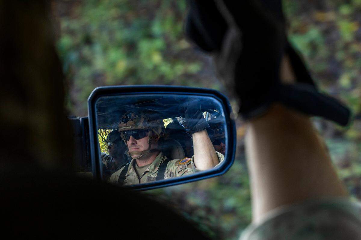 A soldier with the 101st Airborne Division Air Assault, 2nd Brigade Combat Team, from Fort Campbell, Kentucky, rides in an Infantry Squad Vehicles while delivering water, food, toiletries, and other aid to residents in the Soco Gap community in Maggie Valley on Tuesday, October. 8, 2024. The team has been using the Maggie Valley Pavilion and Town Hall as a distribution base for relief efforts in the town following Tropical Storm Helene.