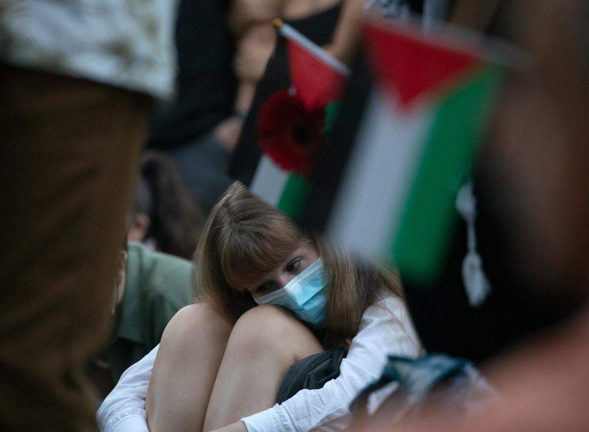 A person listens during a vigil held by the UNC chapter of Students for Justice in Palestine on Monday, Oct. 7, 2024, in Chapel Hill, N.C. The vigil was intended to honor those who have been killed during Israel’s counter-campaign against Hamas in the past year.