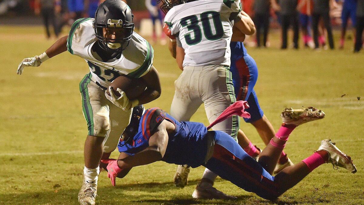 Leesville Road’s DJ Scott (22) runs for the touchdown against Sanderson’s Zion Myers (21) during the second quarter. The Sanderson Spartans and the Leesville Road Pride met in a football game in Raleigh, N.C. on October 22, 2021.