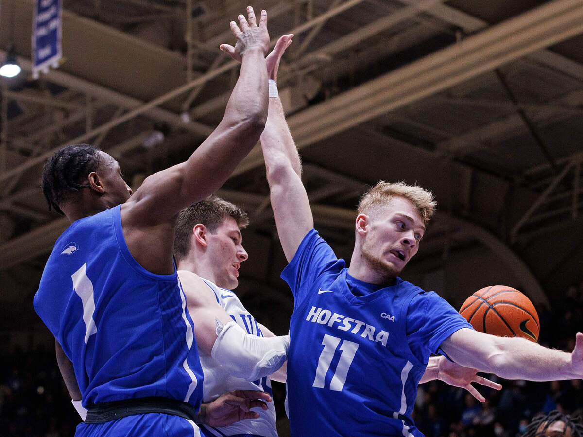 Duke’s Kyle Filipowski looks to pass around Hofstra’s Darlinstone Dubar and Jacco Fritz during the second half of the Blue Devils’ 89-68 win on Tuesday, Dec. 12, 2023, at Cameron Indoor Stadium in Durham, N.C.