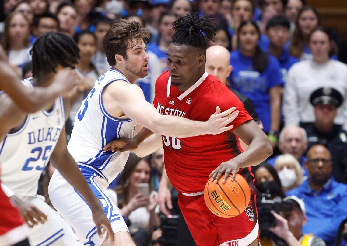 N.C. State’s D.J. Burns Jr. (30) drives past Duke’s Ryan Young (15) during the first half of N.C. State’s game against Duke at Cameron Indoor Stadium in Durham, N.C., Tuesday, Feb. 28, 2023.