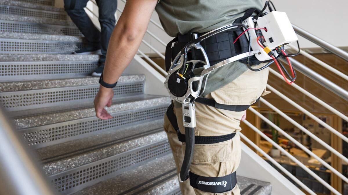 Ivan Lopez demonstrates how the AI robotic exoskeleton can assist with walking up stairs at the Biomechatronics and Intelligent Robotics Lab at N.C. State in Raleigh on Monday, July 1, 2024.
