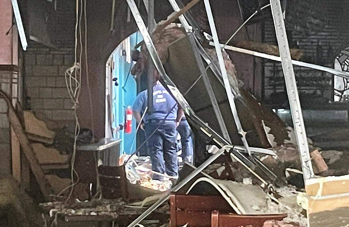 Chapel Hill Fire Department officials tour the inside of Mediterranean Deli on West Franklin Street. The restaurant and four other businesses were damaged when a fire broke out while the roof was being repaired on Saturday, July 22, 2023.