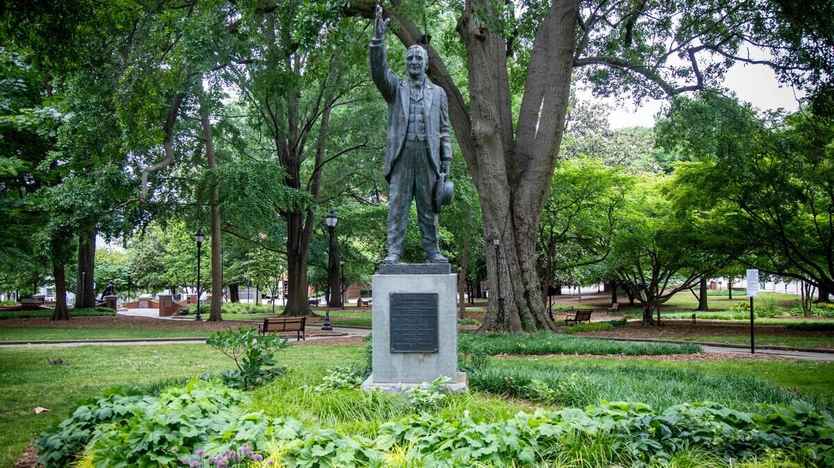 A statue of Josephus Daniels, former owner and editor of The News & Observer and Secretary of the Navy, stands on Nash Square across the street from the former News & Observer building in downtown Raleigh Friday, May 8, 2020. A former North Carolina representative wants historical context about a racist government coup to be added to the Josephus Daniels statue in downtown Raleigh.