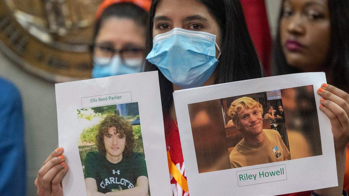 Leah Krevat of Students Demand Action holds a photograph of Reed Parlier and Riley Howell during a press conference demanding gun legislation at the N.C. General Assembly on June 9, 2022 after the mass shooting in Uvalde, Texas. Parlier, of Midland, and Howell, of Waynesville, were killed by a gunman during a 2019 mass shooting on the UNC Charlotte campus.