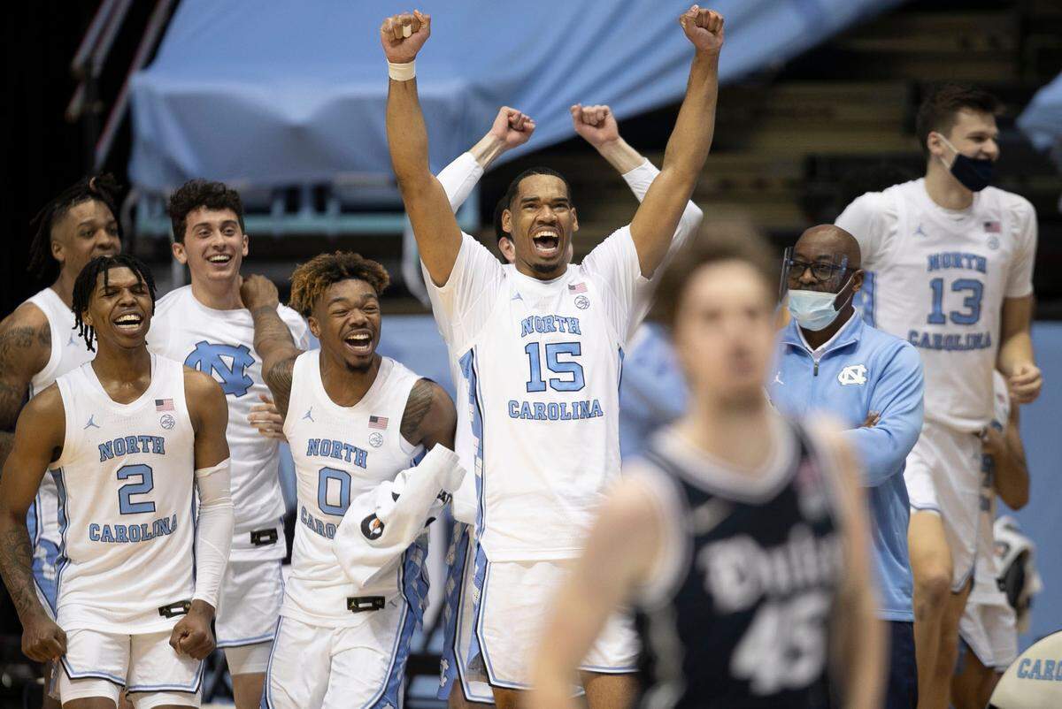 North Carolina’s Garrison Brooks (15) and his teammates reacts as time expires and they celebrate their 91-73 victory over Duke on Saturday, March 6, 2021 at the Smith Center in Chapel Hill, N.C.