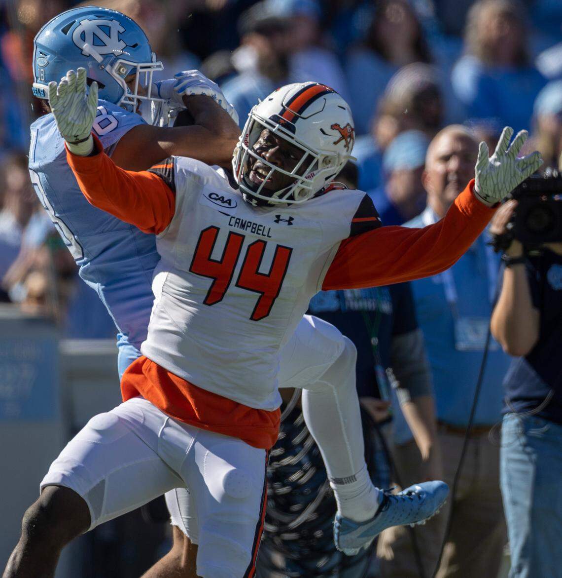 Campbell’s Ed Dennis (44) defends North Carolina’s Bryson Nesbitt (18) on a pass reception from quarterback Drake Maye in the first quarter on Saturday, November 4. 2023 at Kenan Stadium in Chapel Hill, N.C.