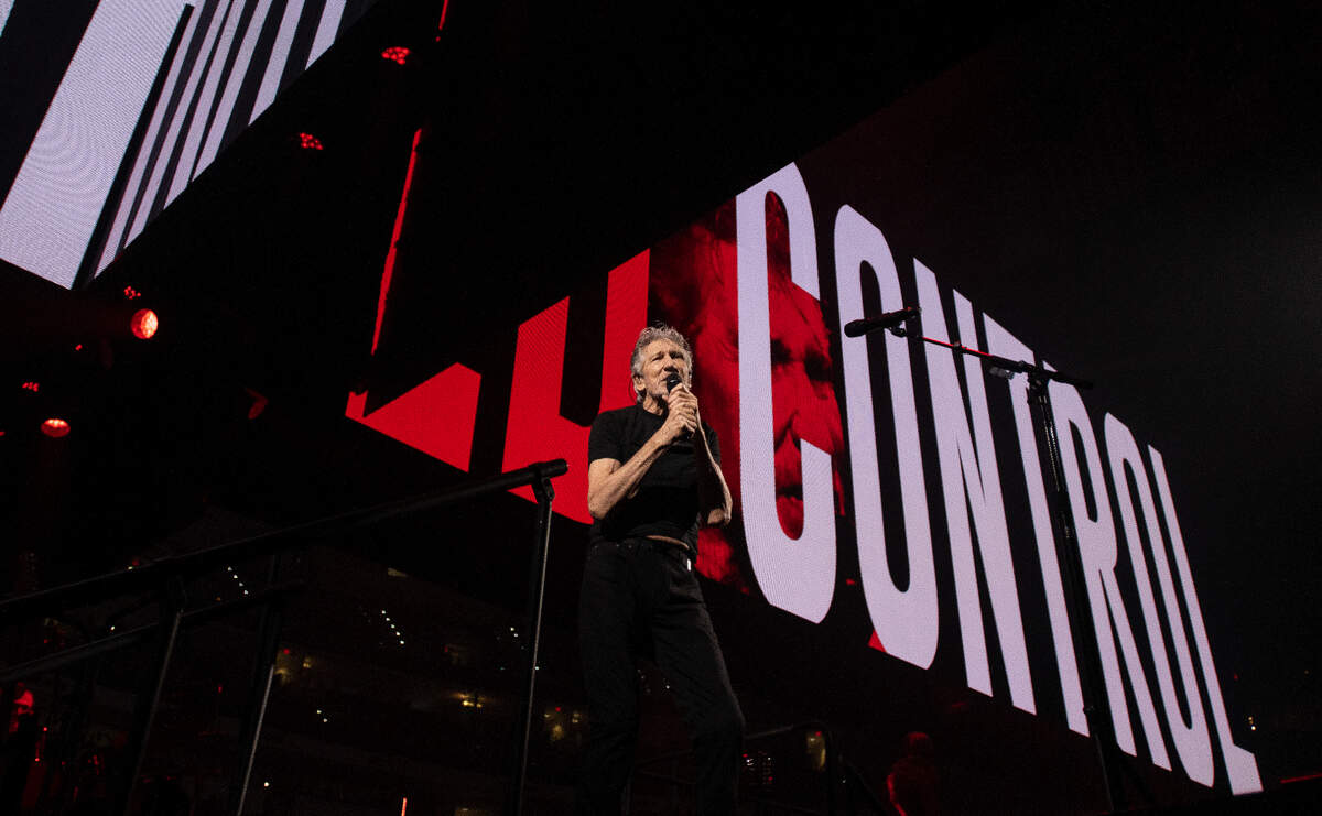 Roger Waters performs in concert at Raleigh, N.C.’s PNC Arena, Thursday night, Aug. 18, 2022 as messages scroll on video screens above his head.