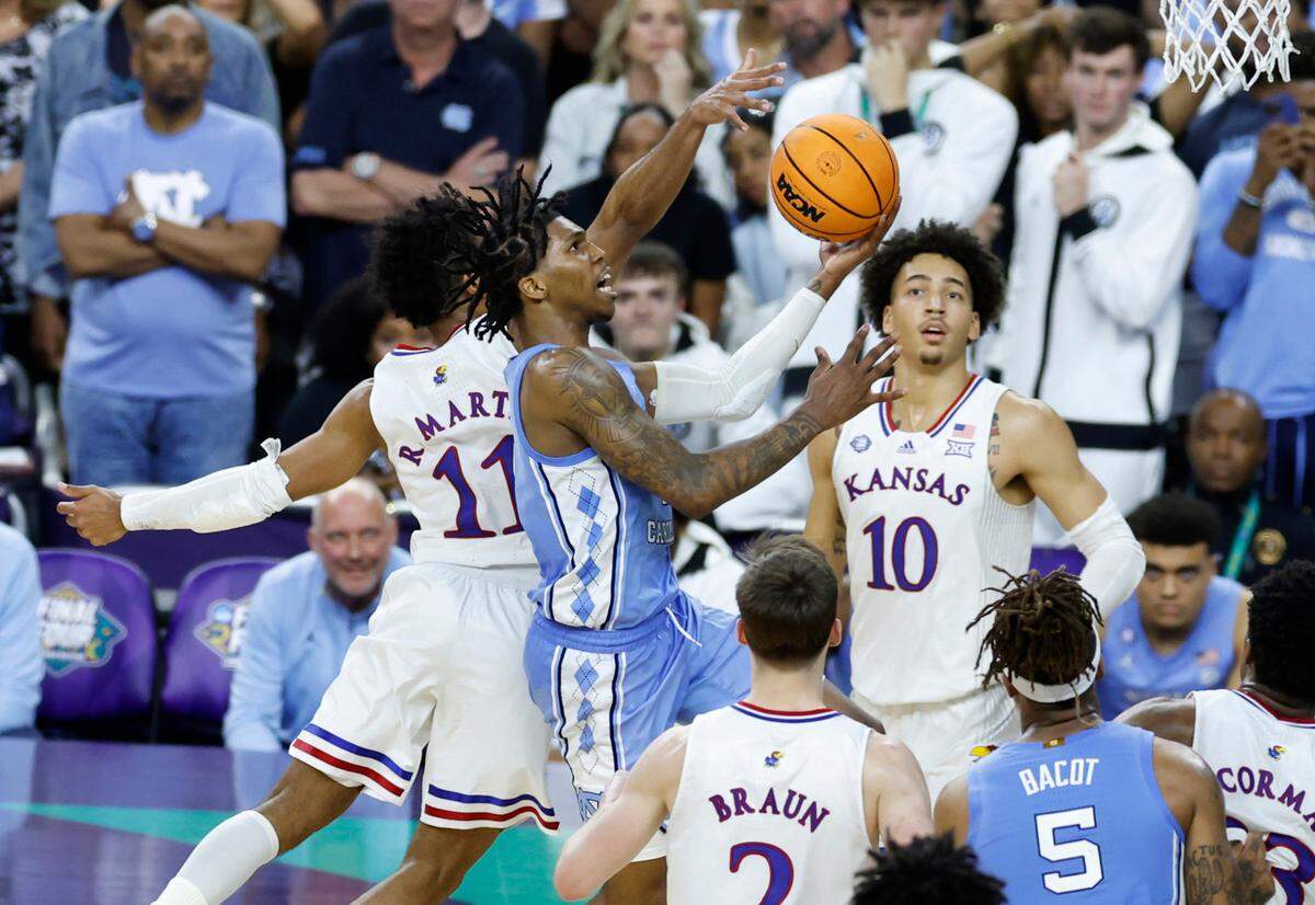 Kansas’ Remy Martin (11) heads to block the layup on North Carolina’s Caleb Love (2) during the second half of Kansas’ 72-69 victory over UNC in the NCAA Men’s National Championship at the Caesars Superdome in New Orleans, La., Monday, April 4, 2022.