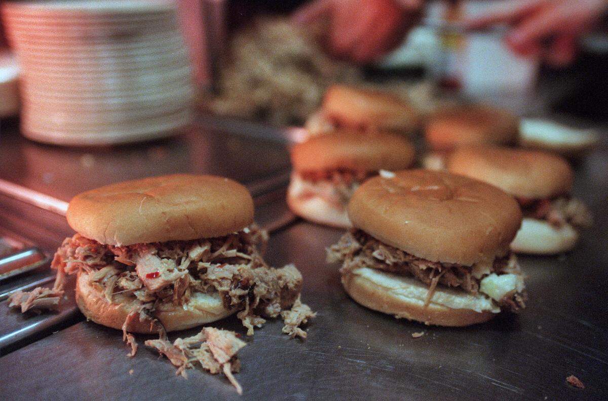 Barbecue sandwiches, full of chopped pork and slaw, line up for take out at Wilber’s Barbecue in Goldsboro.