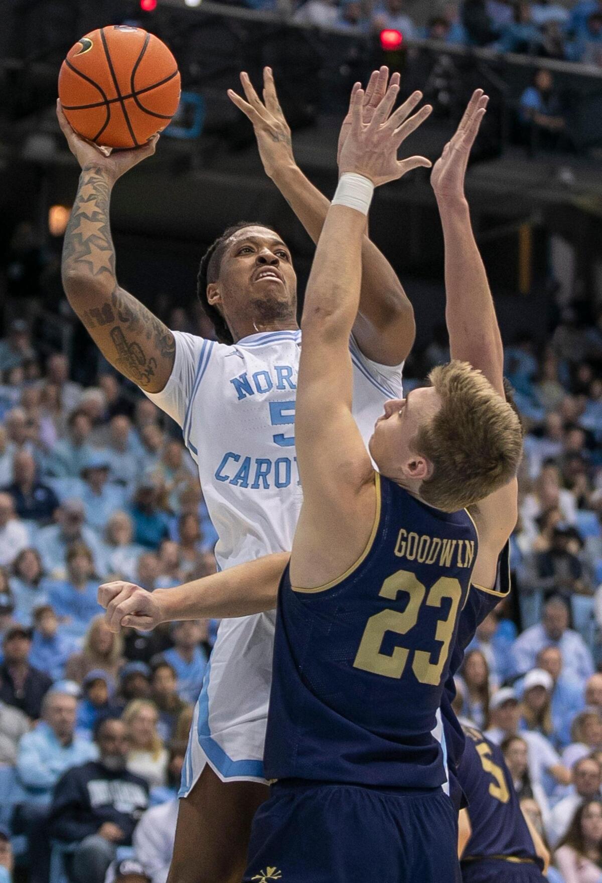 North Carolina’s Armando Bacot (5) is double teamed by Notre Dame’s Nate Laszewski (14) and Dane Goodwin (23) in the first half on Saturday, January 7, 2023 at the Smith Center in Chapel Hill, N.C. Bacot lead all scores with 21 points in the Tar Heels’ 81-64 victory.