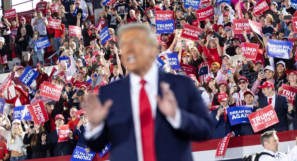 Republican presidential nominee and former President Donald Trump leaves the stage following a rally at Dorton Arena in Raleigh on Monday, Nov. 4, 2024, one day before Election Day.