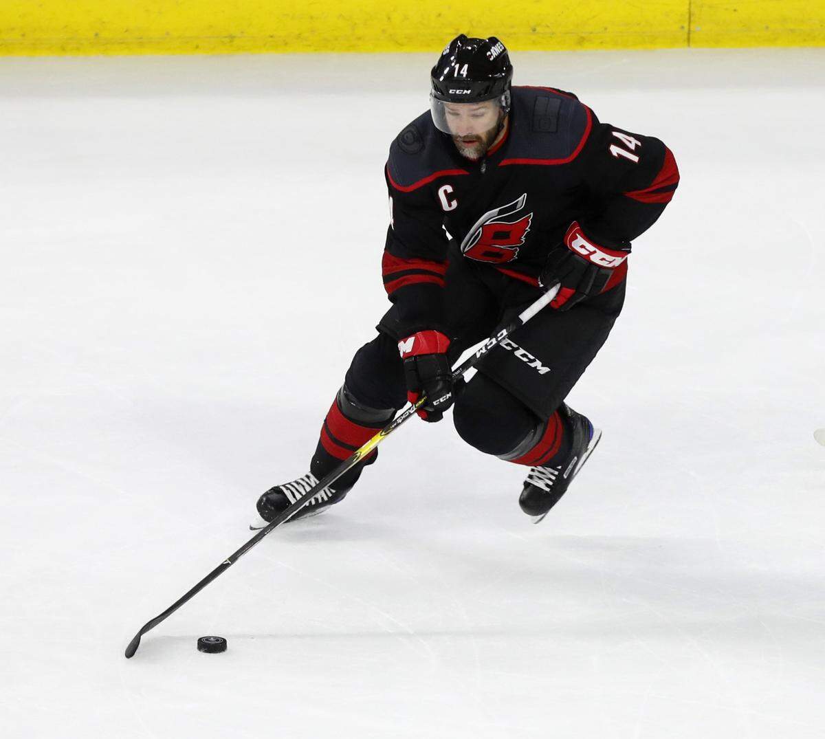 Carolina’s Justin Williams (14) keeps control of the puck during the first period of the Carolina Hurricanes’ game against the Boston Bruins in game four of the Eastern Conference finals at PNC Arena in Raleigh, N.C. Thursday, May 16, 2019.