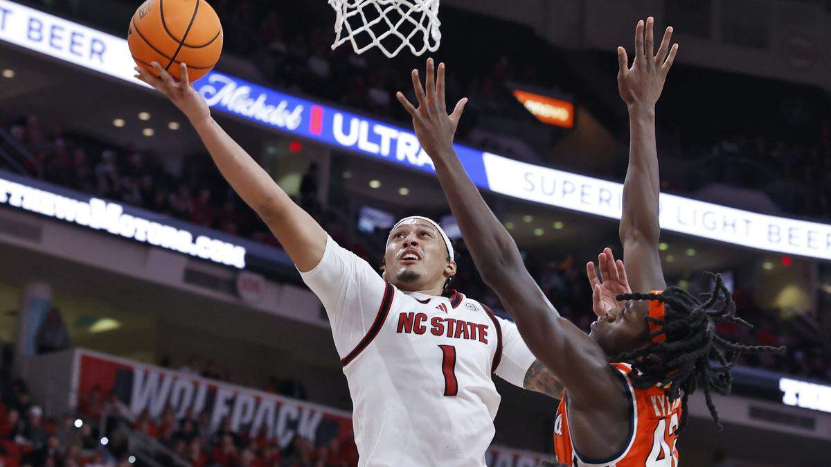 N.C. State’s Darrion Williams drives to the basket past Syracuse’s William Kyle III during the second half of the Wolfpack’s 88-68 win on Tuesday, Jan. 27, 2026, at Lenovo Center in Raleigh, N.C.