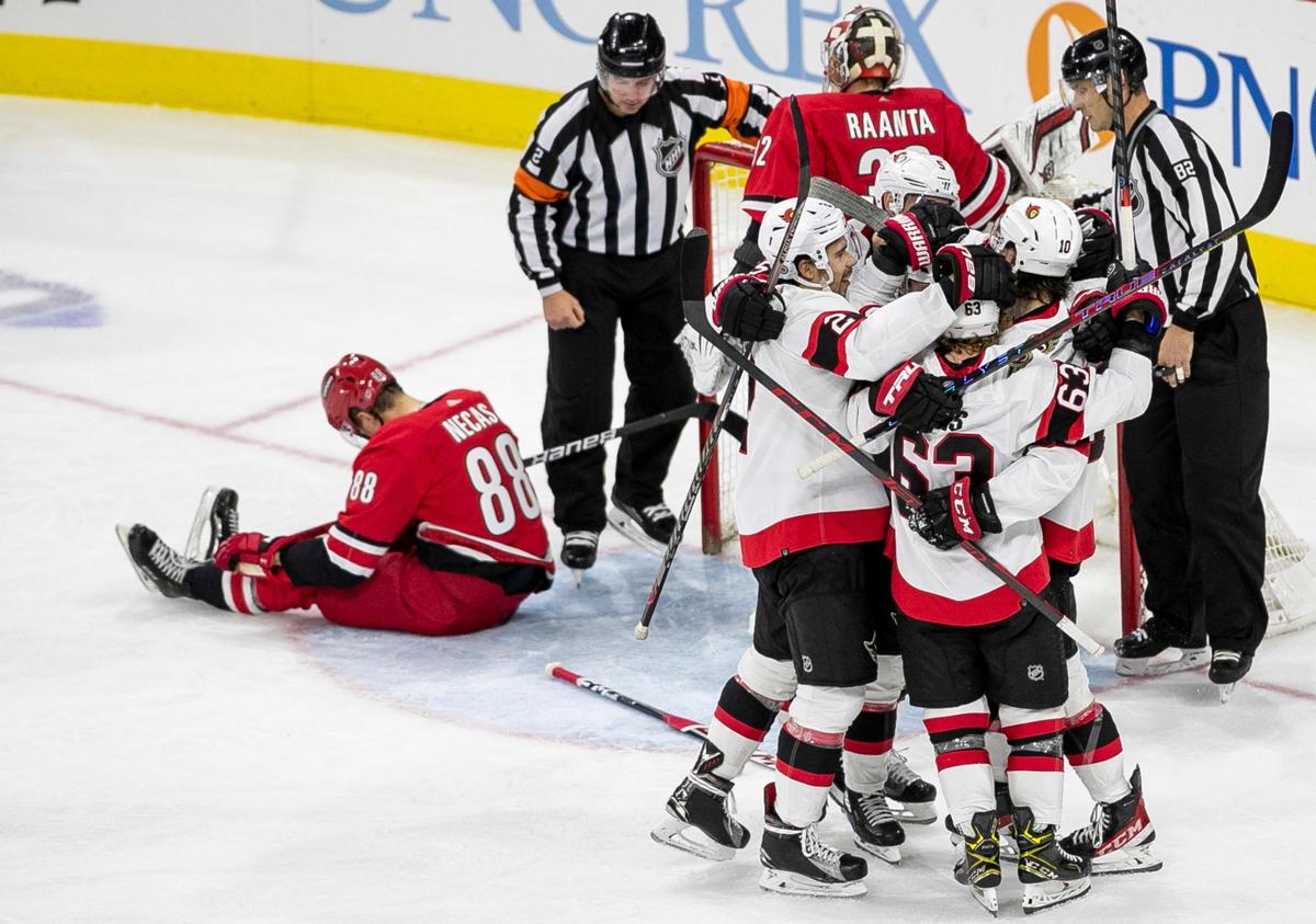 Ottawa’s Alex Formenton (10) is surrounded by teammates after scoring on Carolina Hurricanes’ goalie Antii Raanta (32) in the third period to take a 2-0 lead on Thursday, December 2, 2021 at PNC Arena in Raleigh, N.C. The Senators defeated the Hurricanes 3-2.