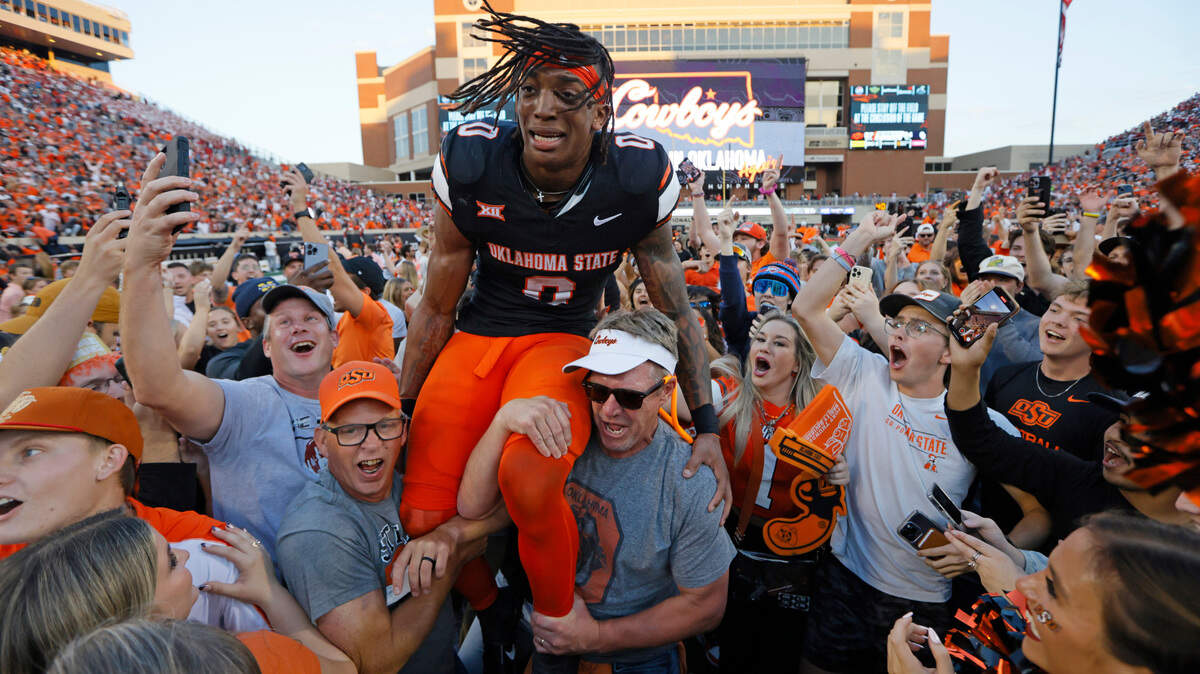 Nov 4, 2023; Stillwater, Oklahoma, USA; Oklahoma State Cowboys running back Ollie Gordon II (0) celebrates with fans after a Bedlam college football game between the Oklahoma State University Cowboys (OSU) and the University of Oklahoma Sooners (OU) at Boone Pickens Stadium.