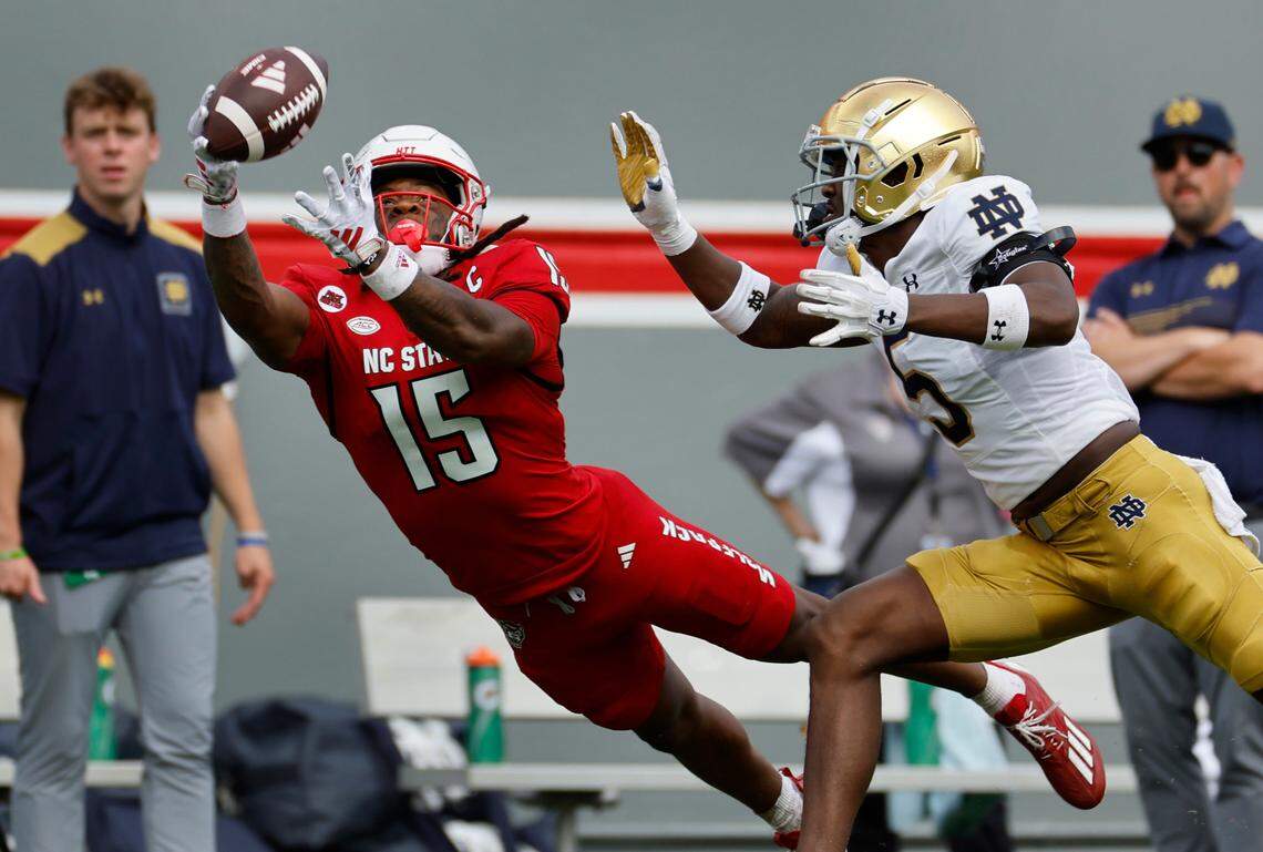 N.C. State wide receiver Keyon Lesane (15) pulls in the 38-yard reception with one hand as Notre Dame cornerback Cam Hart (5) defends during the second half of Notre Dame’s 45-24 victory over N.C. State at Carter-Finley Stadium in Raleigh, N.C., Saturday, Sept. 9, 2023.