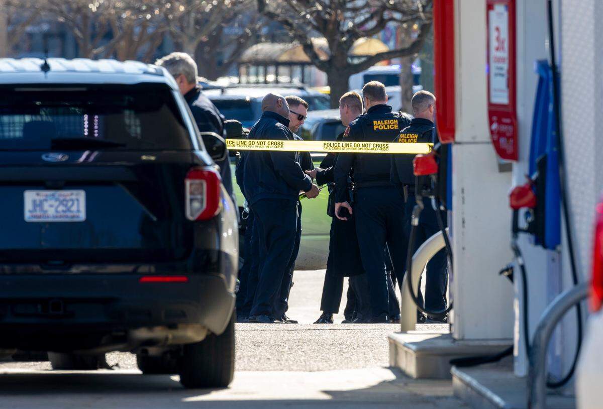 Raleigh Police investigate a possible shooting in N. Hills, adjacent to the Exxon station at the intersection of Lassiter Mill Road and Six Forks Road on Friday, January 17, 2025 in Raleigh, N.C.