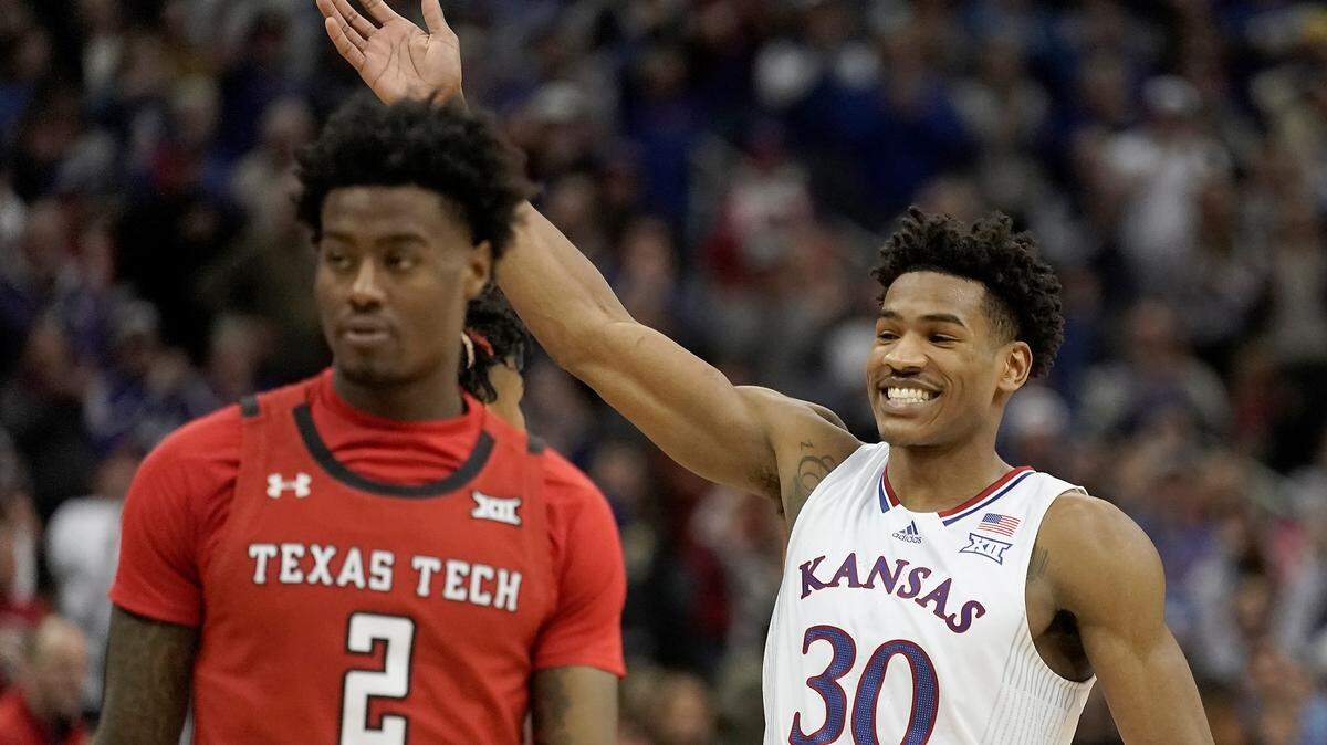 Kansas guard Ochai Agbaji (30) celebrates after an NCAA college basketball championship game against Texas Tech in the Big 12 Conference tournament in Kansas City, Mo., Saturday, March 12, 2022. Kansas won 74-65.
