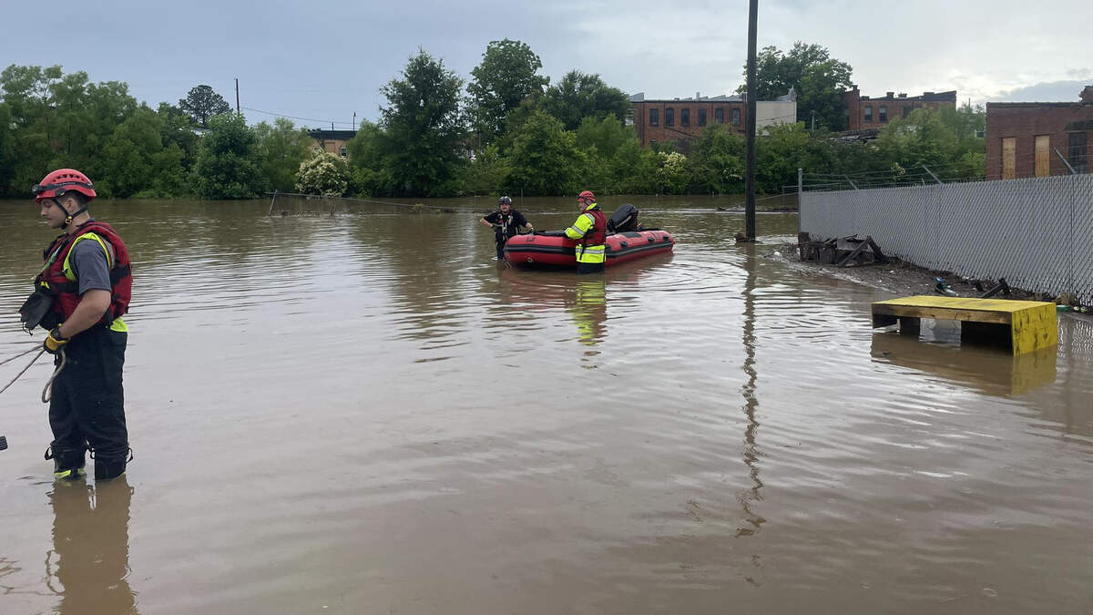 Emergency workers prepare for water rescues in downtown Sanford following flooding from heavy rains, Thursday, June 5, 2025.
