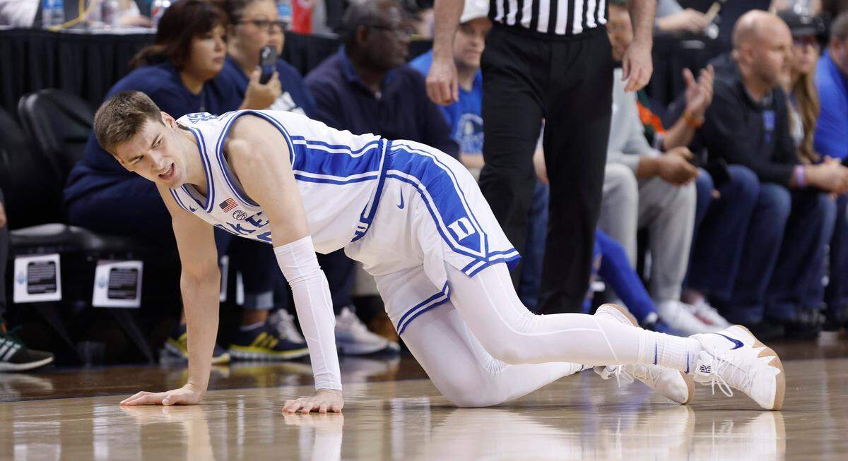 Duke’s Kyle Filipowski (30) tries to get up after being injured during Duke’s game against Pitt in the quarterfinals of the ACC Men’s Basketball Tournament in Greensboro, N.C., Thursday, March 9, 2023.