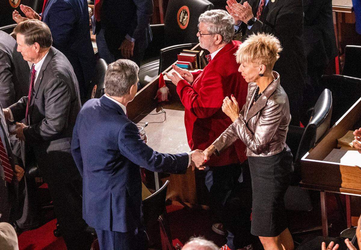 North Carolina State Auditor Beth Wood shakes Gov. Roy Cooper’s hand following his State of the State address during a joint session of the N.C. General Assembly on Monday, March 6, 2023.