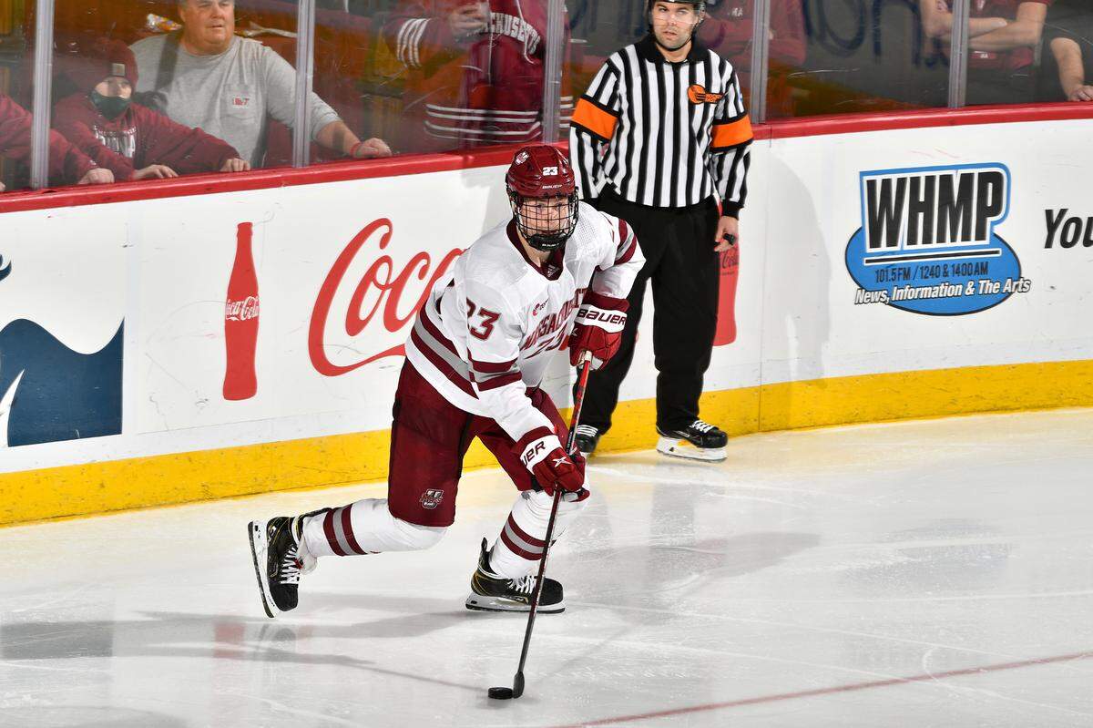 Scott Morrow (23) of the University of Massachusetts handles the puck in the corner in action earlier this season. Morrow is among 10 Hurricanes prospects playing in this year’s IIHF World Junior Championships.