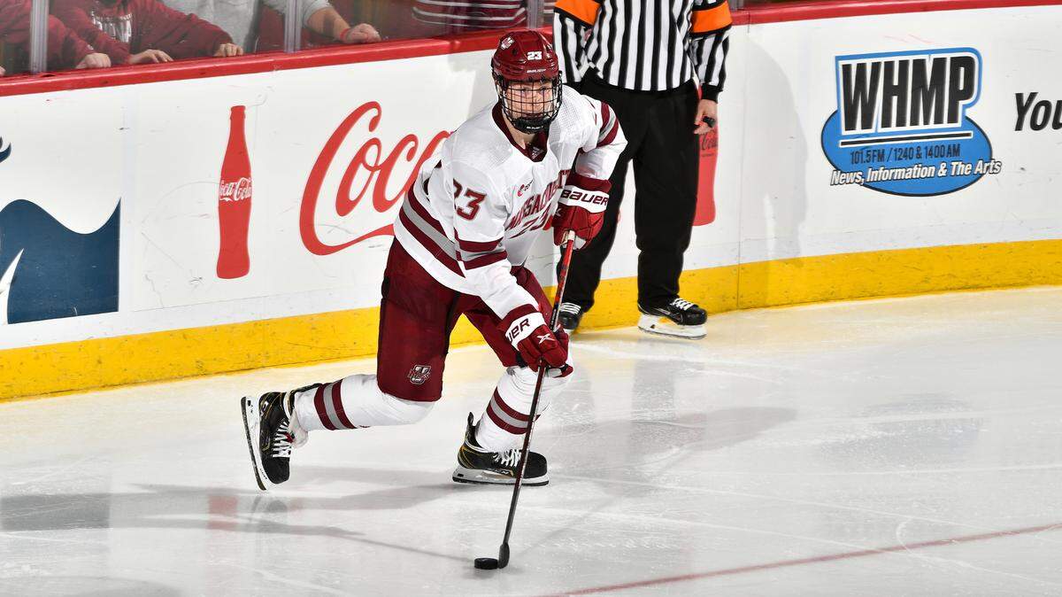 Scott Morrow (23) of the University of Massachusetts handles the puck in the corner in action earlier this season. Morrow is among 10 Hurricanes prospects playing in this year’s IIHF World Junior Championships.