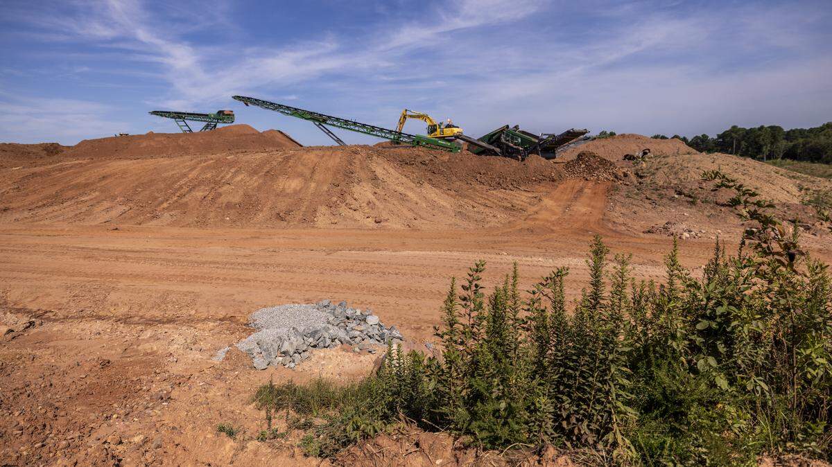 Raleigh-Durham International Airport is replacing its aging main runway with a new, longer one next to it. In this photo from summer 2025, contractors work to create a level surface by moving huge amounts of rock and dirt, a process that will continue through this year.