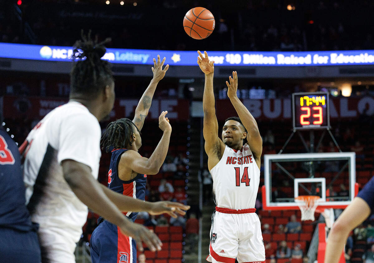 N.C. State’s Casey Morsell shoots over the Detroit defense during the second half of the Wolfpack’s 83-66 win on Saturday, Dec. 23, 2023, at PNC Arena in Raleigh, N.C.