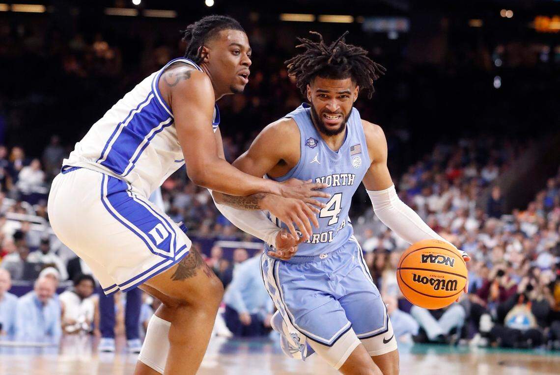 North Carolina’s R.J. Davis (4) drives around Dukes Trevor Keels (1) during the first half of Dukes game against UNC in the Final Four at Caesars Superdome in New Orleans, La., Saturday, April 2, 2022.