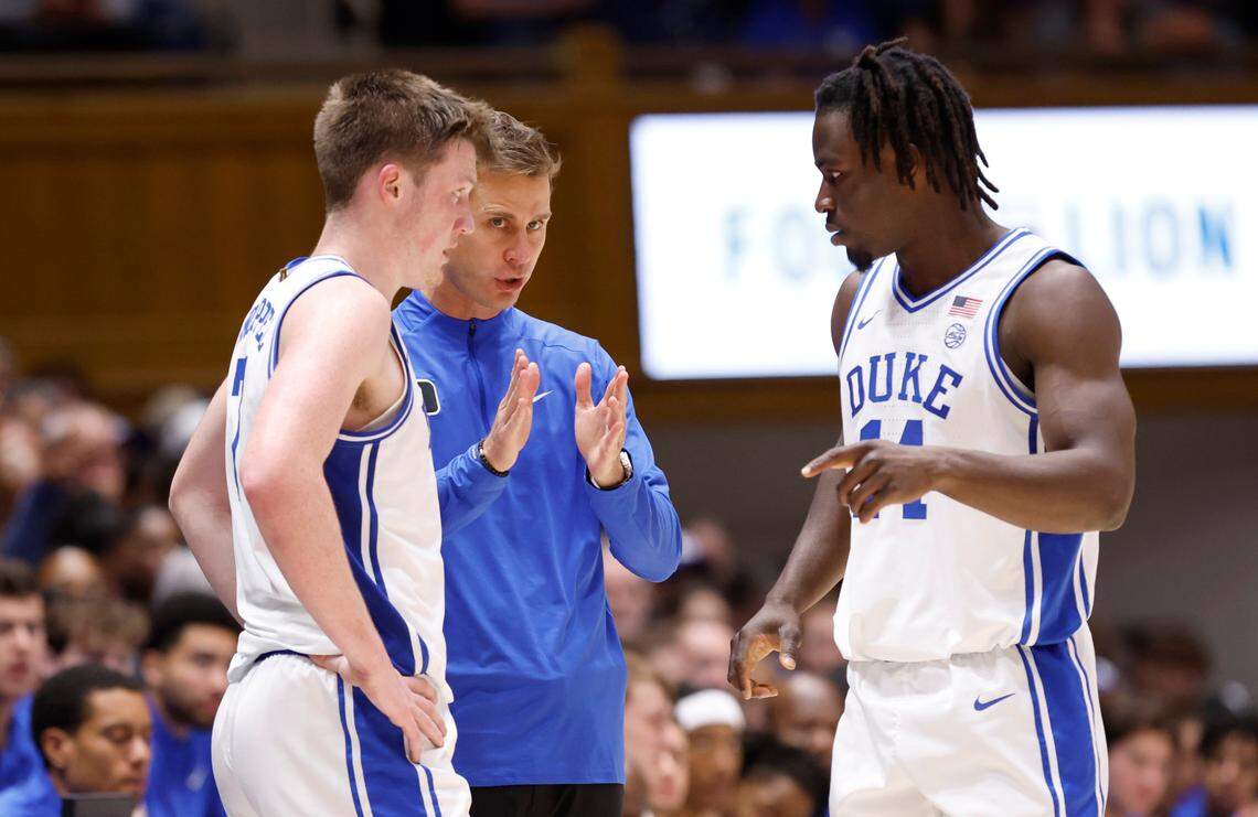 Duke head coach Jon Scheyer talks with Kon Knueppel (7) and Sion James (14) during the first half of Duke’s exhibition game against Lincoln (Pa) University at Cameron Indoor Stadium in Durham, N.C., Saturday, Oct. 19, 2024.