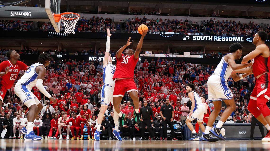 N.C. State’s DJ Burns Jr. (30) shoots as Duke’s Kyle Filipowski (30) defends during N.C. State’s 76-64 victory over Duke in their NCAA Tournament Elite Eight matchup at the American Airlines Center in Dallas, Texas, Sunday, March 31, 2024.