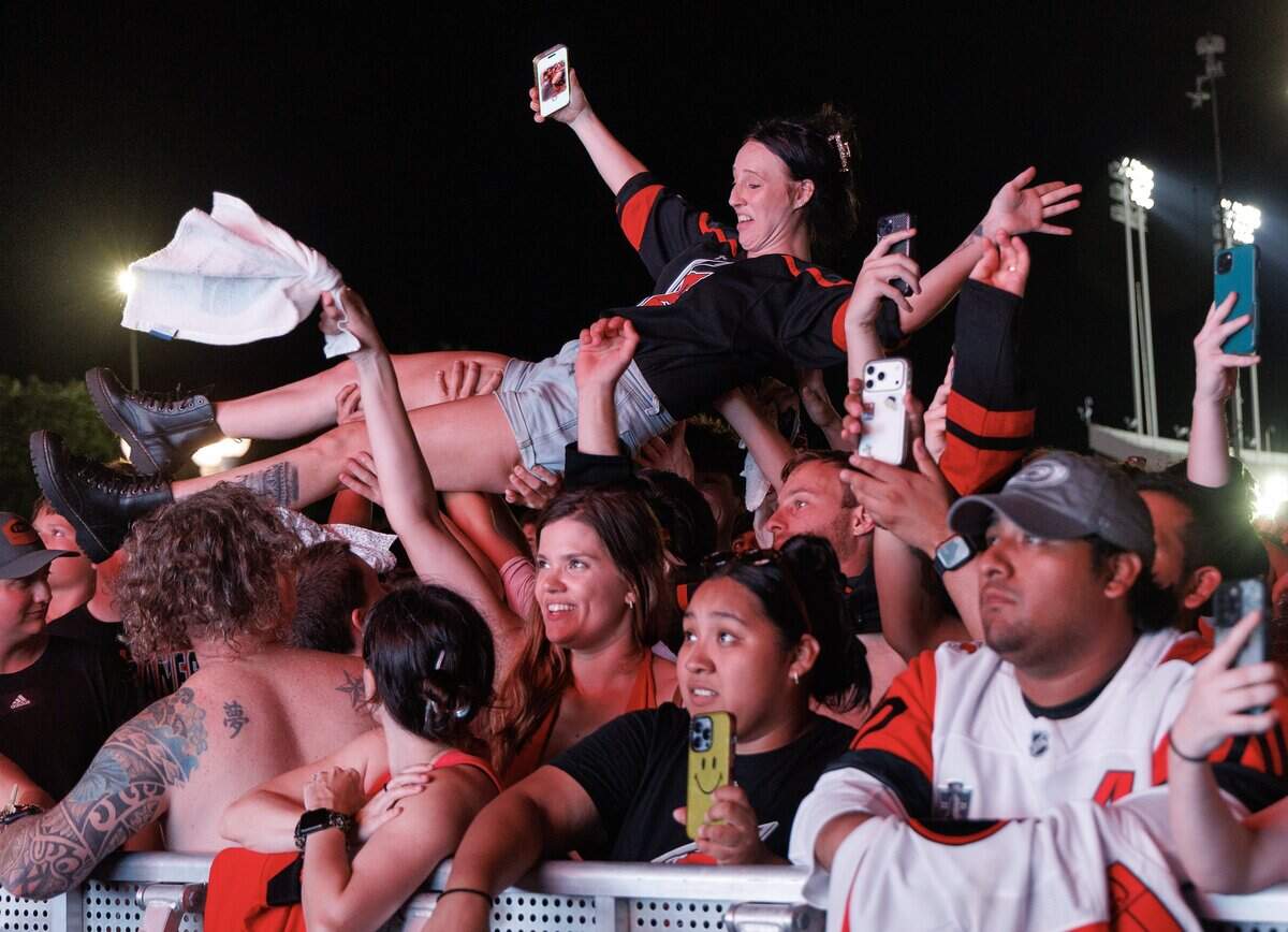 A person crowd surfs as Carolina Hurricanes fans celebrate the team’s Stanley Cup victory over the Vegas Golden Knights during a watch party outside the Lenovo Center on Sunday, June 14, 2026, in Raleigh, N.C.