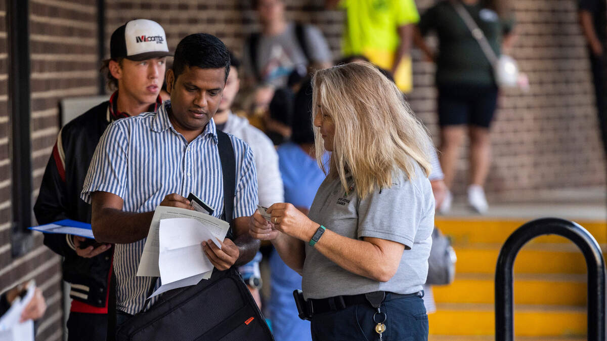 Drivers license examiner helps Gokul Annamalai make sure his documents are in order at the NC Department of Motor Vehicles’ West Raleigh Driver License Office Friday morning, Sept. 2, 2022.