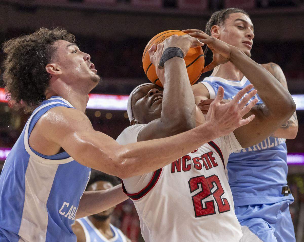 N.C. State forward Ven-Allen Lubin (22) battles for a rebound with North Carolina center Zayden High (1) and guard Kyan Evans (0) in the first half on Tuesday, February 17, 2026 at Lenovo Center in Raleigh, N.C.