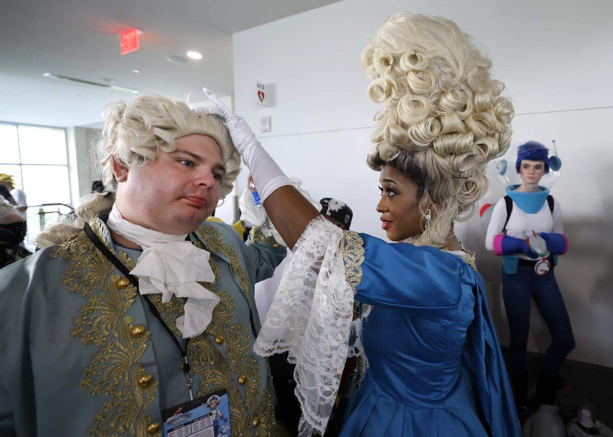 Robin Waden of High Point helps adjust the wig of Dakota Holt of Mayodan before the costume contest at GalaxyCon Raleigh at the Raleigh Convention Center Saturday, July 26, 2025. Waden is cosplaying as Queen Charlotte from A Bridgerton Story and Holt is King George.