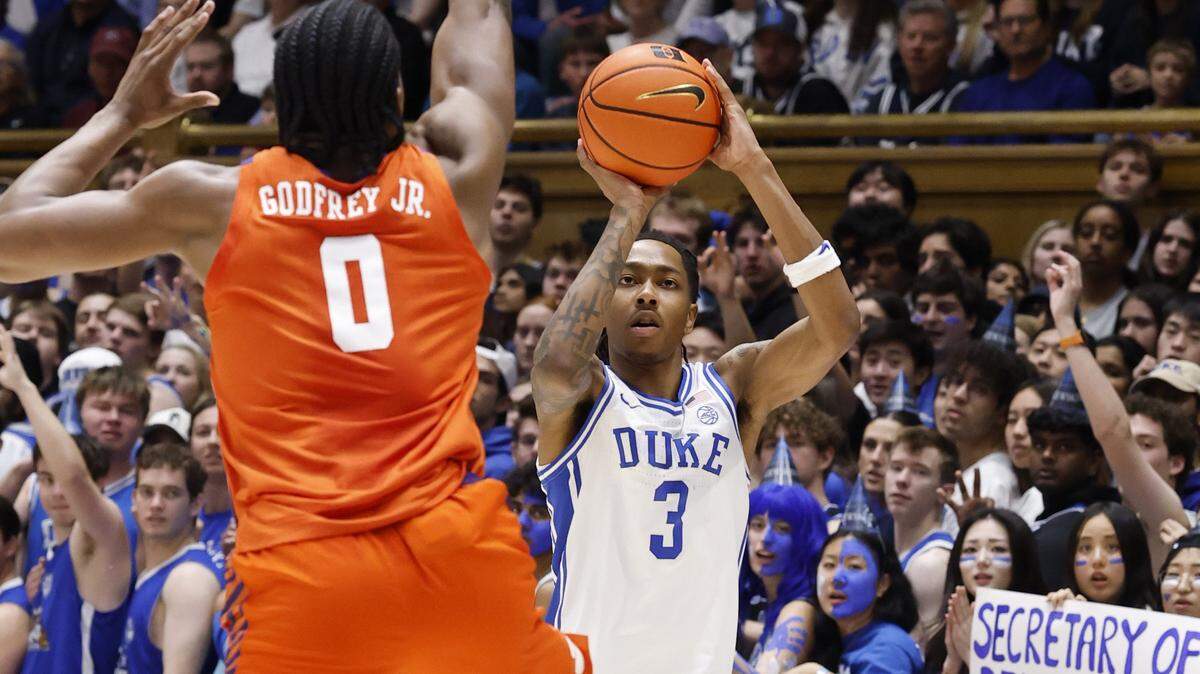 Duke’s Isaiah Evans (3) hits a three-pointer as Clemson's RJ Godfrey (0) defends during the first half of Duke’s game against Clemson at Cameron Indoor Stadium in Durham, N.C., Sat., Feb. 14, 2026.